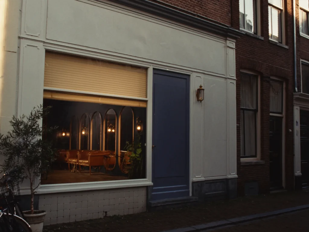 The slate-blue shopfront of Kapsalon De Meester on the Dorpsstraat in Amersfoort