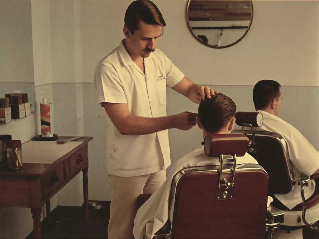 Willem de Meester cutting a client's hair in his first barbershop in 1978